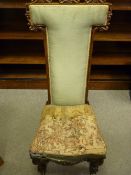 A VICTORIAN ROSEWOOD PRE DIEU CHAIR having a 'T' shaped back with carved decoration and satin