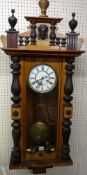 A VICTORIAN VIENNA STYLE WALL CLOCK, the brass and enamel dial set with Roman numerals, brass