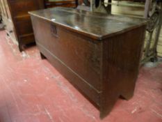 A LATE 18th CENTURY OAK SWORD CHEST, the two plank lid with iron strap hinges and lock plate, iron