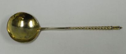 A RUSSIAN SILVER GILT SPOON with floral engraved bowl and monogram and having a spiral stem,