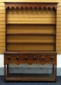 A NINETEENTH CENTURY WEST WALES DRESSER in oak having three drawers raised above a platform base and