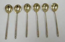 A SET OF SIX RUSSIAN SILVER COFFEE SPOONS the pear shaped bowls decorated in relief with a floral