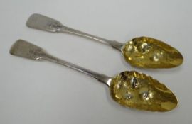 A PAIR OF GEORGE III SILVER BERRY SPOONS with monogrammed and foral chased terminals and raised