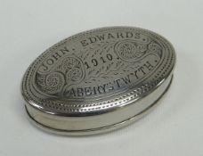 AN OVAL WHITE METAL TOBACCO BOX with hinged lid, the base and lid with sgraffito decoration and
