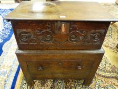 A LATE 18th/EARLY 19th CENTURY OAK BIBLE BOX having a carved scrolled and swirled front with iron