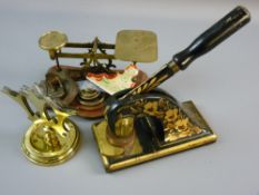 A SET OF BRASS AVERY POSTAL SCALES on a wooden base with five weights, a floral decorated office