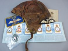 A WWI PILOT'S LEATHER FLYING HELMET with pop button peak and ear flaps, an album of JBS cigarette