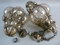 A PAIR OF VENETIAN STYLE HALL LANTERNS, wrought iron scroll frame work with blown glass, 34 cms