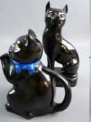 A LATE 19th CENTURY BLACK JACKFIELD POTTERY SEATED CAT on a hollow oval base, 19 cms high (slight