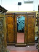 A VICTORIAN MAHOGANY BREAKFRONT TRIPLE WARDROBE, the centre having a full length bevelled mirror and