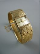A LADY'S ACCURIST NINE CARAT GOLD WRISTWATCH, 28 grms total, in original box