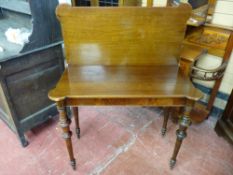 A LATE 19th/EARLY 20th CENTURY POLISHED AND MAHOGANY FOLDOVER TEA TABLE having an oblong top with