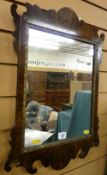 A REPRODUCTION GEORGIAN STYLE MIRROR in a shaped walnut and mahogany frame, 59 x 40 cms