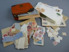 A JACOB'S BISCUIT TIN OF LOOSE STAMPS, an envelope of similar and a small quantity of first day