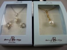 A BOXED PAVE YELLOW METAL NECKLET with pearl drop pendant and a white metal necklet with pearl drops