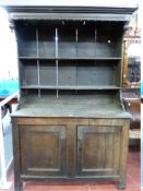 AN EARLY 18th CENTURY SIMPLE OAK WELSH DRESSER with twin shelf rack having a deep hood