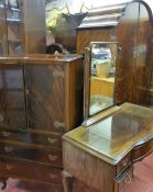 AN EARLY 20th CENTURY DARK MAHOGANY BEDROOM SUITE, the double wardrobe of domed form with tallboy