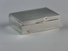 A HALLMARKED SILVER CIGARETTE BOX with cedar wood interior, Birmingham 1938 (dented, hallmark