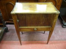 A REGENCY MAHOGANY NIGHT CABINET, the shaped top over a tambour front and single frieze drawer