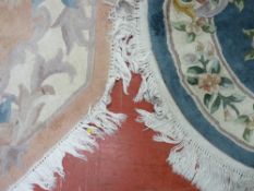 TWO CHINESE WASHED WOOLLEN RUGS, a hexagonal example, 155 cms long and a floral patterned on a