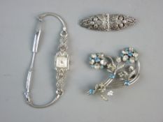 A LADY'S COCKTAIL WATCH having a square dial, marcasite encrusted with loop connectors to the