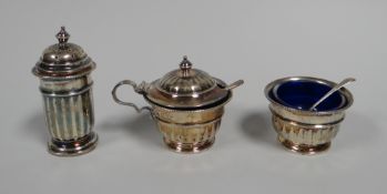 A THREE PIECE SILVER CRUET SET of circular form, 4ozs