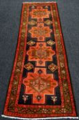 A BLACK GROUND CERISE PINK DOOR DESIGN IRANIAN RUNNER, 335 x 105cms