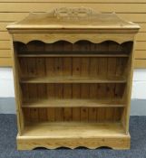 A PINE OPEN BOOKCASE with openwork carved rail, 107cms wide