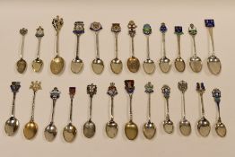 A COLLECTION OF TWENTY-FOUR SILVER SOUVENIR SPOONS for British and Irish resorts, all but three with