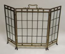 A FOLDING BRASS AND GLASS FIRESCREEN