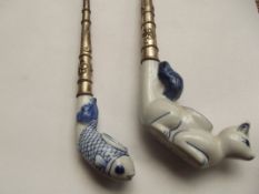 2 white metal and ceramic pipes