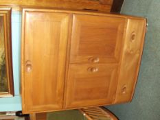 Ercol bureau in light elm, the fall flap above a t