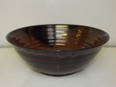Large studio pottery bowl with a Tenmoku glaze by