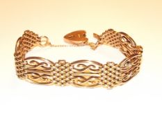 A 9ct yellow gold gate bracelet with safety chain