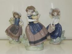 Three Lladro figures of young girls, tallest 18cm.