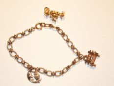 9ct gold charm bracelet with 3 charms. Approx 12 g