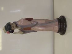 Lladro figure depicting oriental lady standing wit