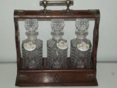 An edwardian tantalus with cut glass decanters al