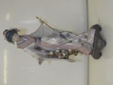 Lladro figure depicting oriental lady standing wit