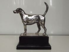 Cast silver figure of a hound, modelled in an aler