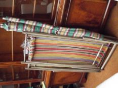Two vintage deck chairs together with a wind scree