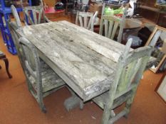 Large heavy rustic garden table and six chairs, na