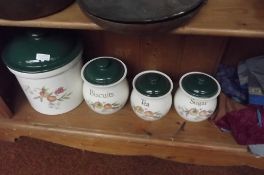 Three large storage jars, tea, sugar, biscuits