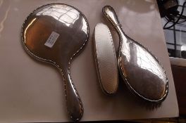 2 brushes and a mirror in silver