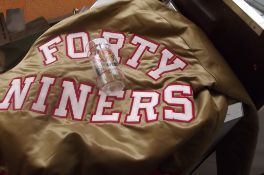 NFL 49'ers jacket together with a 49'ers glass