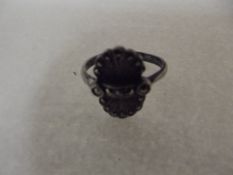 Silver ring with ornate fan design head set with m