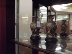 Pair of small oriental vases on plint