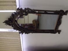 Victorian mahogany rococo style mirror in mahogany, the frame faded to a good colour, 132cm x 75cm