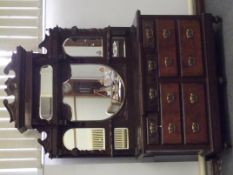Victorian sideboard, the mirrored top with swan neck pediment having turned and carved supports. the