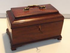 19th century mahogany tea caddy, sarcophagus form, the hinged lid with applied brass swing handle